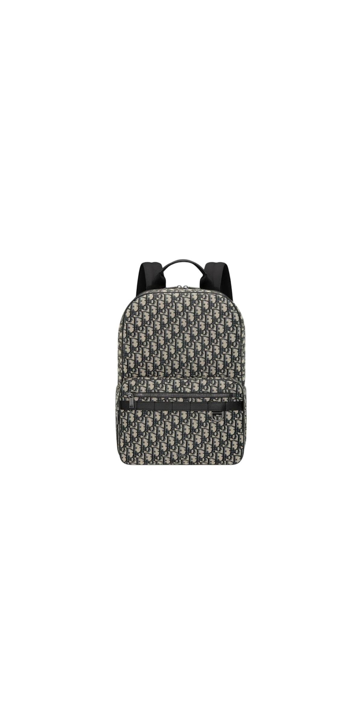 Front view — Dior Men's Safari Backpack in beige and navy blue Dior Oblique jacquard with front zip pocket, padded shoulder straps and 'DIOR' hardware detail