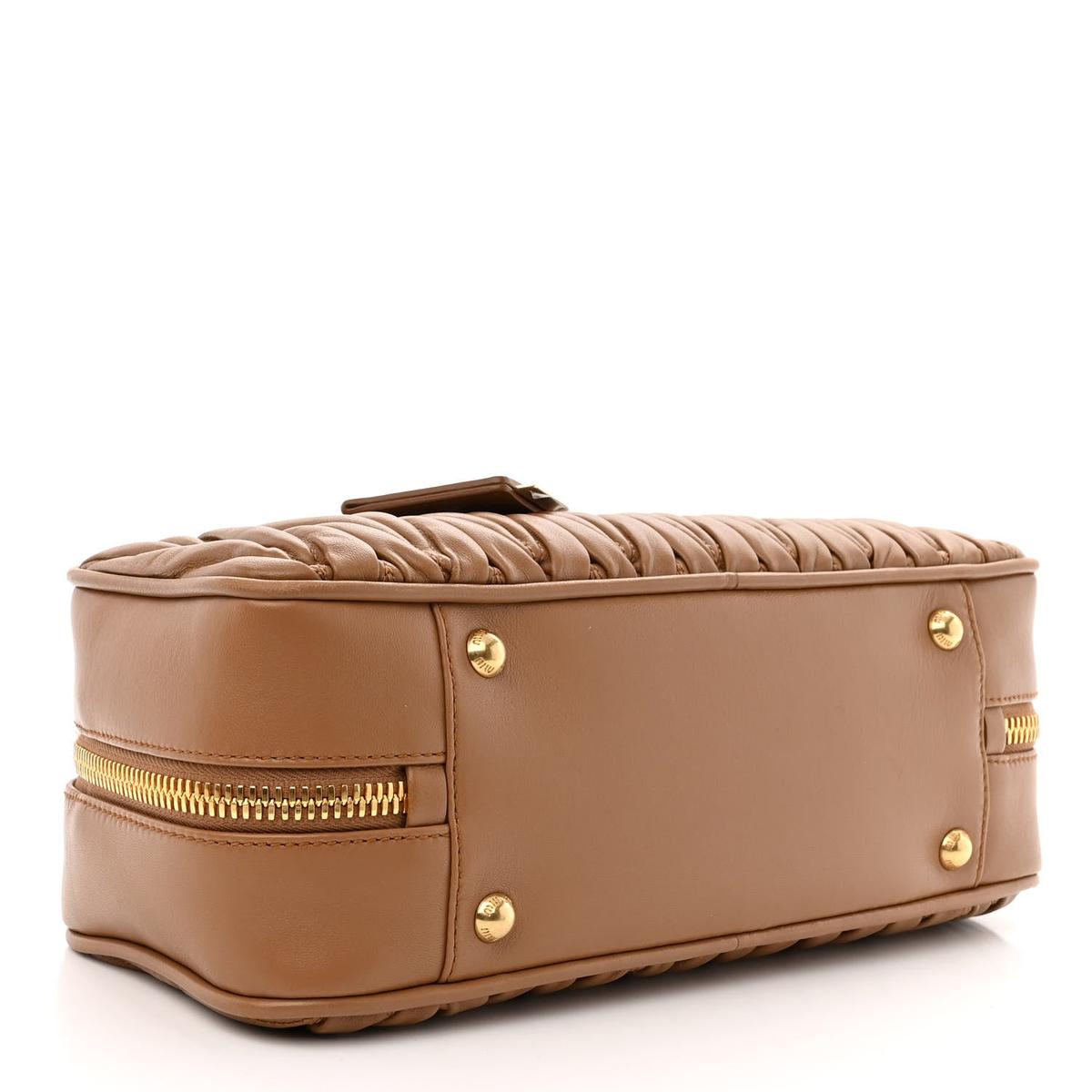 Bottom view showing matelasse quilted leather and expansion zipper detail